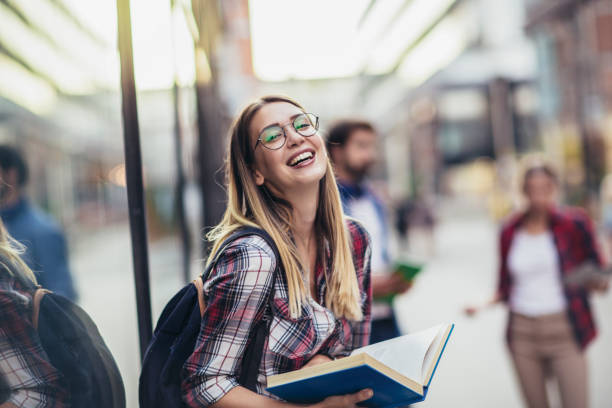 istock Happy university student going on a class at the university and looking at camera. 1411369693
