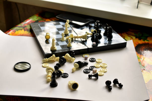 istock Chess pieces lie on the table, on a white sheet and a chessboard. 1411371322