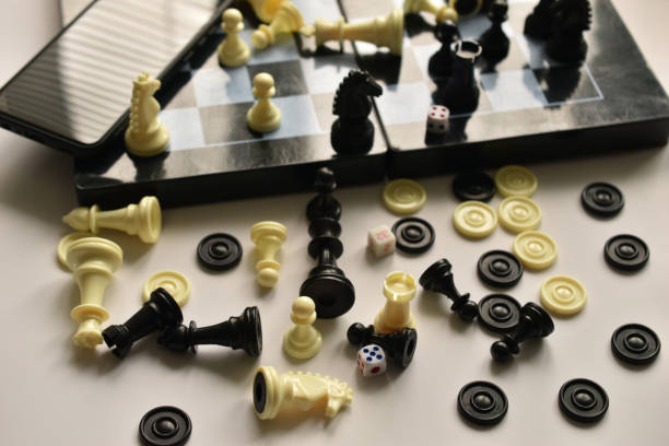 istock Chess pieces lie randomly on the table and the chessboard. 1411371438
