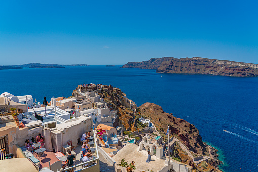 OIA, GREECE - MAY 22.2022: View of londsa castle in Oia with traditional white houses, Santorini island, Greece