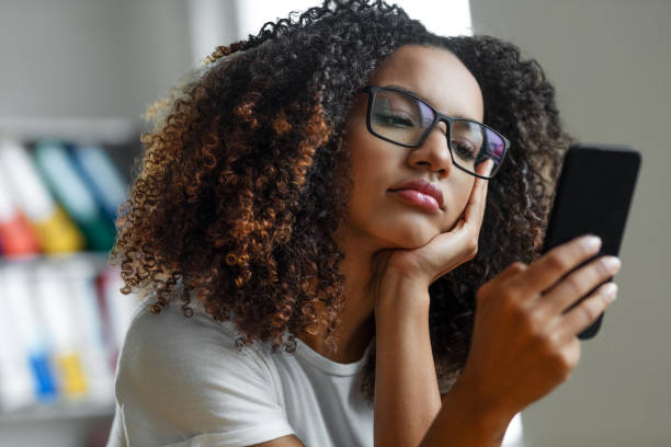 istock Woman looking at mobile phone screen 1411373433