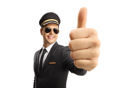 Professional young chauffeur showing thumbs up and smiling isolated on white background