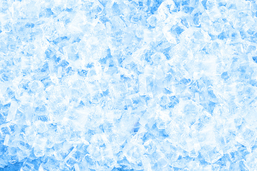 Ice Cubes and Water Drops on Blue Background.
