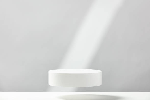 istock Abstract empty white podium with geometric shadows on blue background. Mock up stand for product presentation. 3D Render. Minimal concept 1411375303