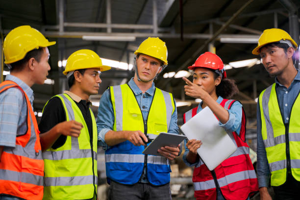 istock Blue collar worker works with machine at factory. 1411375472