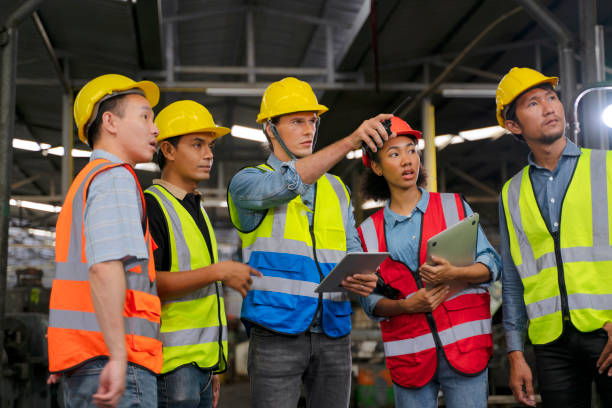 istock Blue collar worker works with machine at factory. 1411375502