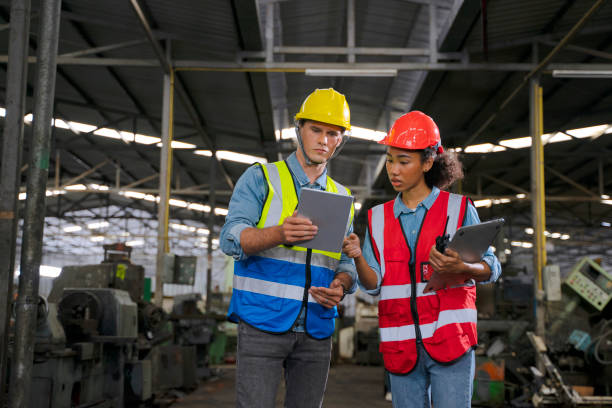 istock Blue collar worker works with machine at factory. 1411375629