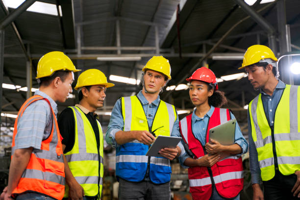 istock Blue collar worker works with machine at factory. 1411375787