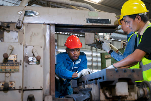istock Blue collar worker works with machine at factory. 1411375789