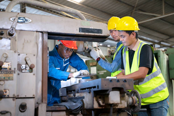 istock Blue collar worker works with machine at factory. 1411375813