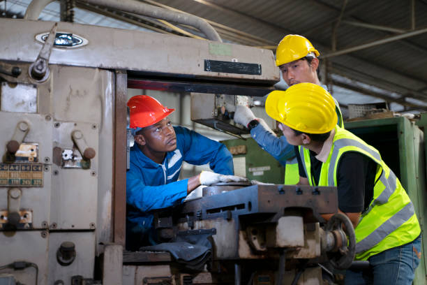 istock Blue collar worker works with machine at factory. 1411375840