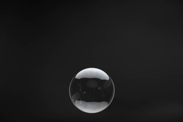 istock Flying soap bubbles on black background. Abstract soap bubbles with reflections. Soap bubbles in motion background. 1411376187