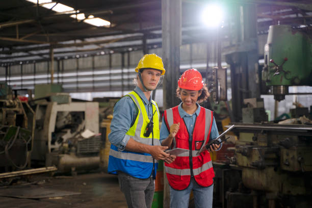 istock Blue collar worker works with machine at factory. 1411377709