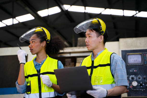 istock Blue collar worker works with machine at factory. 1411377743