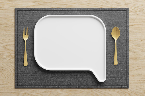 eating dishes on top view. White ceramic plate and placemat text box text chat symbol shape talk with grey fabric wood spoon fork wood on light wood background speech bubble balloon. 3D Illustration.