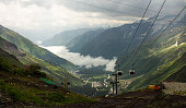 Cable car with cabins rising and descending high in the Caucasus mountains