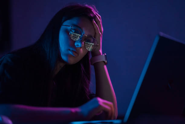 istock Attractive young woman working in home at night. 1411381081
