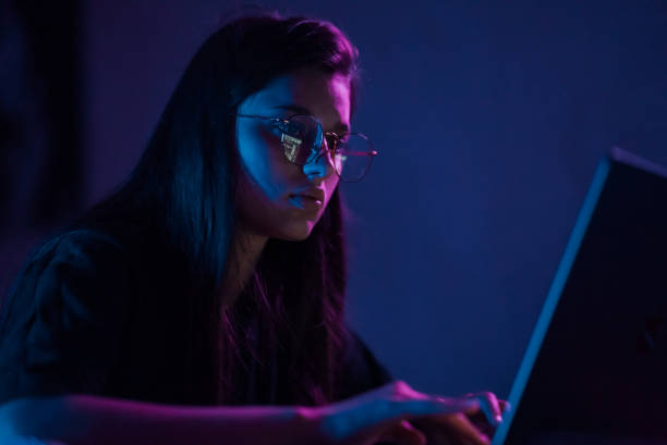 istock Attractive young woman working in home at night. 1411381096