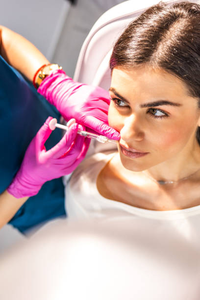 istock Woman Having Injection In Lips As Beauty Treatment 1411381255