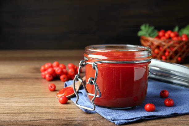 Delicious rowan jam in jar on wooden table. Space for text Delicious rowan jam in jar on wooden table. Space for text rowanberry stock pictures, royalty-free photos & images