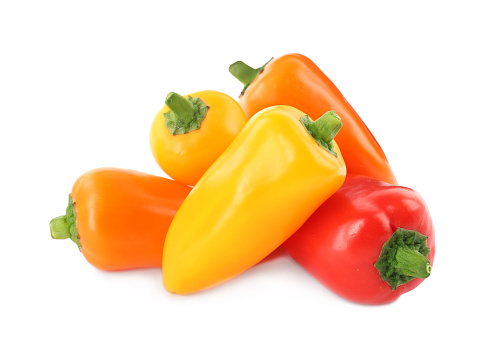 Heap of ripe bell peppers isolated on white