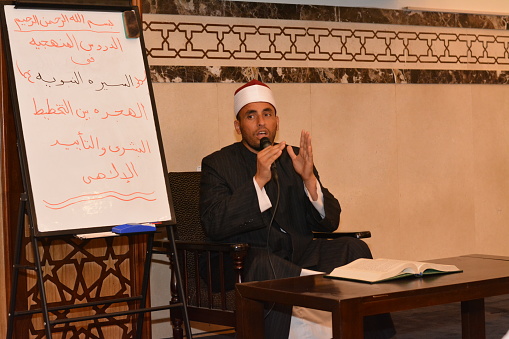 Cairo, Egypt, July 27 2022: A mosque Imam preacher gives a lecture on the prophetic biography and the prophet practices and Sunnah, an Islamic sermon after the prayer inside Al Masjid or the mosque