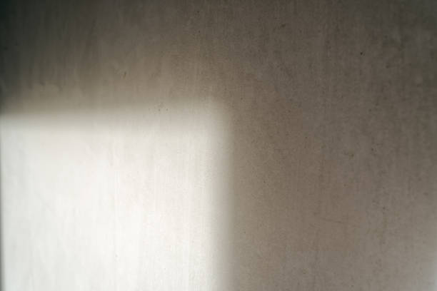istock The light from the window hits the concrete wall inside the room without renovation. Concept of an apartment without finishing works, preparation for renovation. 1411383846