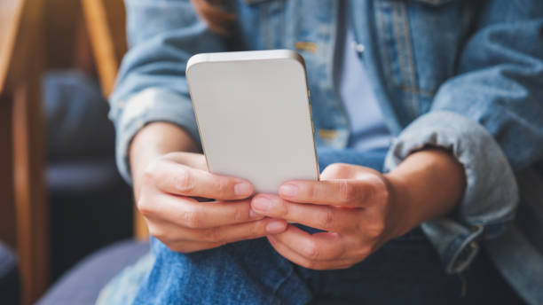 istock Closeup image of a woman holding and using mobile phone 1411385151