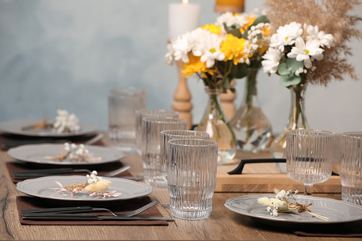 Elegant festive setting with floral decor on wooden table