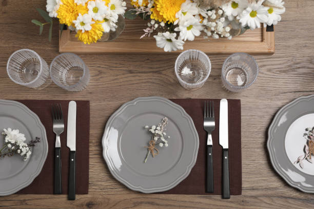 istock Elegant festive setting with floral decor on wooden table, flat lay 1411385339