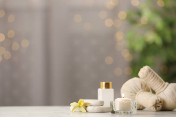 istock Composition with herbal bags and burning candle on white table against blurred festive lights, space for text 1411385543