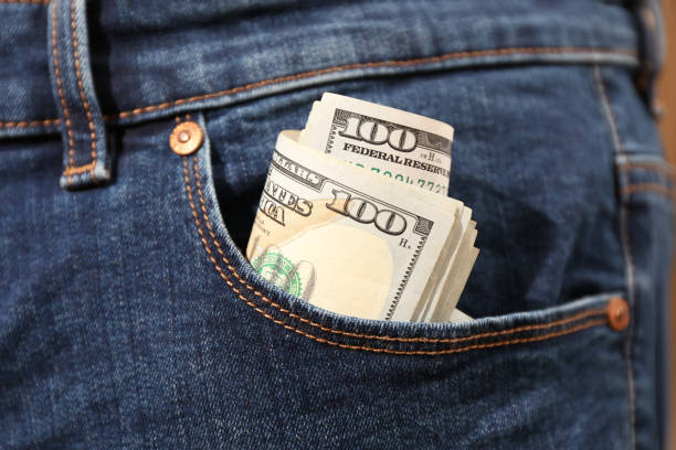 ジーンズのポケットに入ったドル紙幣、クローズアップ。お金を使う - currency paper currency wealth one hundred dollar bill ストックフォトと画像