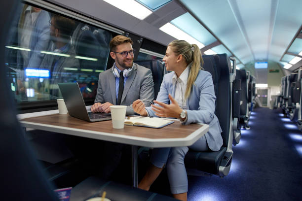 istock Business people traveling and working on the train using laptop 1411386539