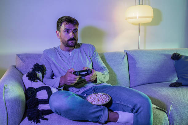 istock Cozy night at home and playing video games online 1411387158