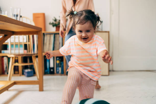 girl running from her mother while playing - criança de 1 a 2 anos imagens e fotografias de stock