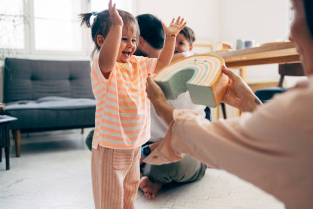 istock Mother Giving Her Daughter A Toy 1411388063