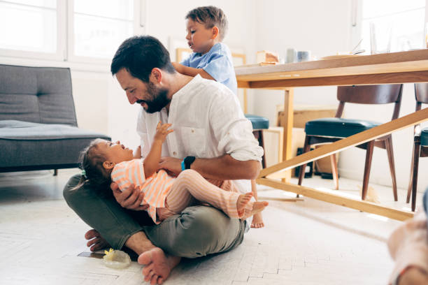 istock Father Playing With His Two Children 1411388064