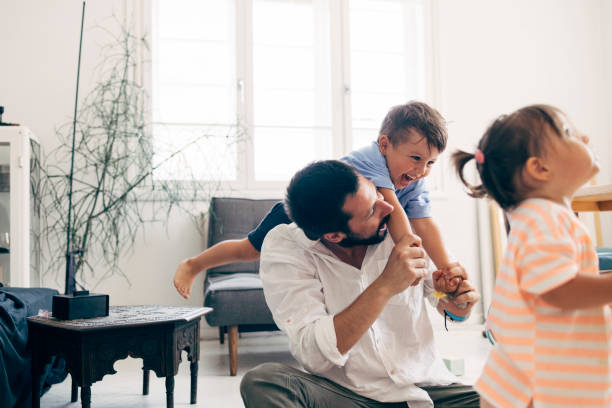 istock Father Playing With His Two Children 1411388078