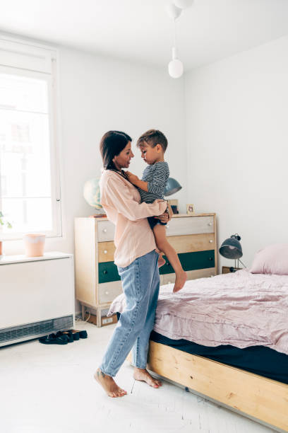 istock Mother Holding Her Son In Her Arms 1411388142