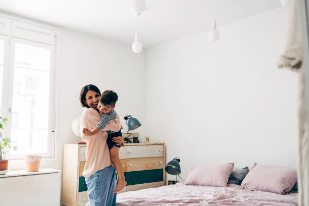 istock Mother Holding Her Son In Her Arms 1411388146