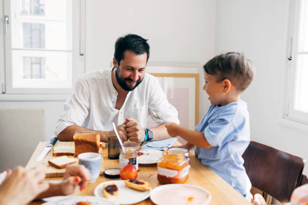 istock Father And His Son Eating Breakfast 1411388178