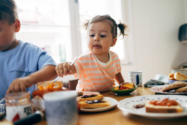 istock Little Girl Eating Jam With A Spoon 1411388180