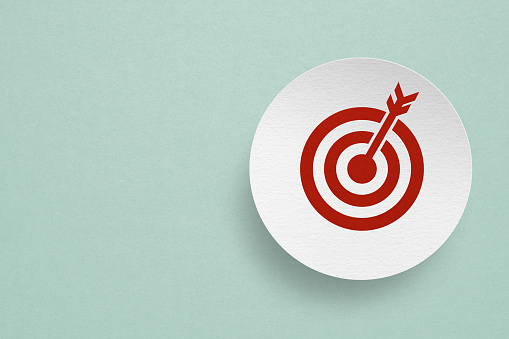 red dartboard icon paper cut on grunge white paper and grunge green background including copy space