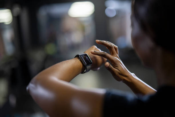 istock Over shoulder close up woman using smart watch 1411395246