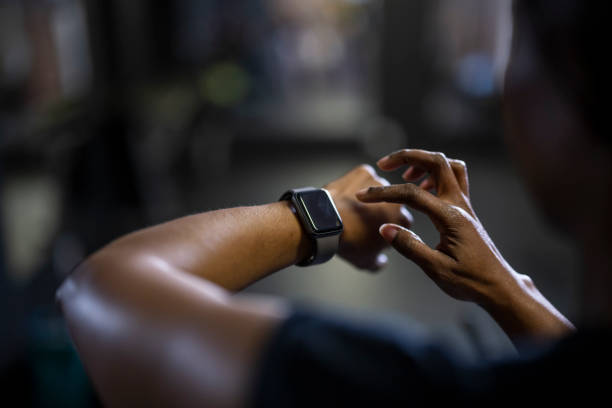 istock Over shoulder close up woman using smart watch 1411395274