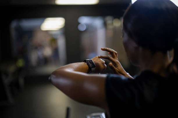 istock Over shoulder woman using smart watch 1411395371