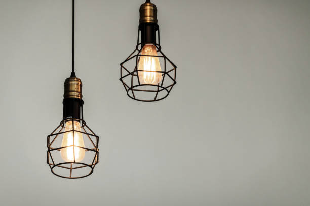 istock Vintage lamp hanging from the ceiling with white wall decorated in hotel 1411397867