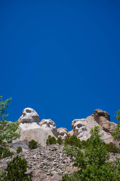 Mount Rushmore National Memorial, Black Hills Region of South Dakota photographed with clear skies Mount Rushmore National Memorial depicts the U.S. presidents George Washington, Thomas Jefferson, Theodore Roosevelt and Abraham Lincoln are carved into Mount Rushmore in the Black Hills. theodore roosevelt us president stock pictures, royalty-free photos & images