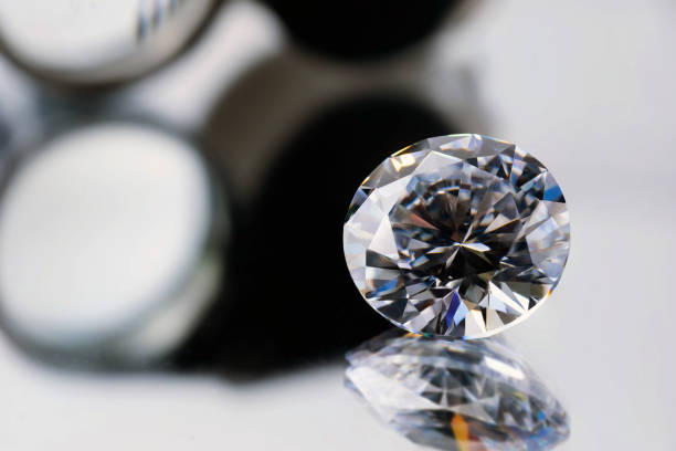 istock brilliant cut diamond held by tweezers on black background 1411397899