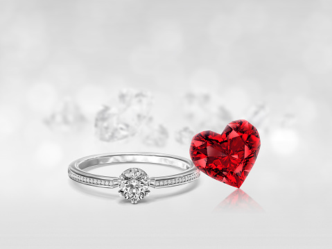Diamond ring and Red Heart shaped diamond on the white diamonds background reflecting. Valentine's Day concept